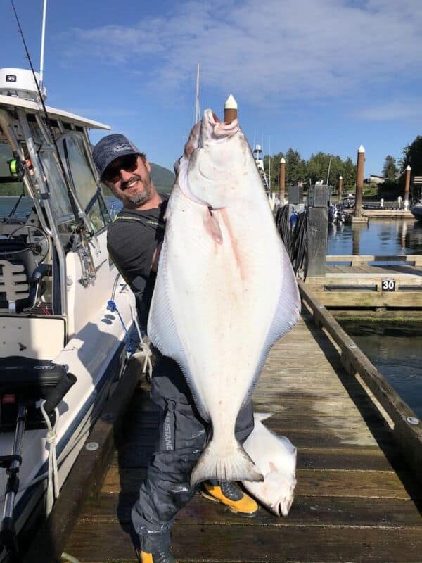 Joel Unickow holding a fresh caught flatfish from a successful West Coast halibut recipe trip.