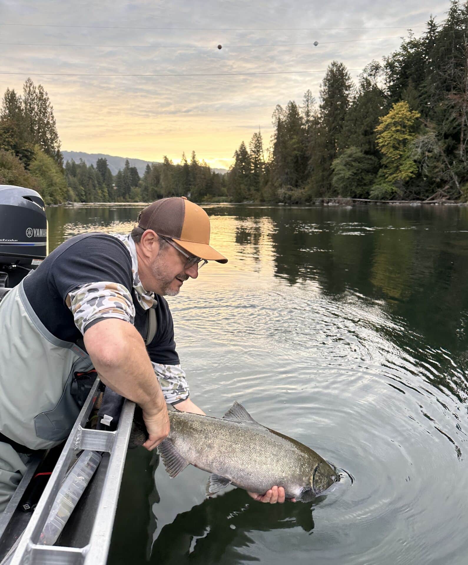 Joel Unickow releasing a Chinook salmon on the Somass River