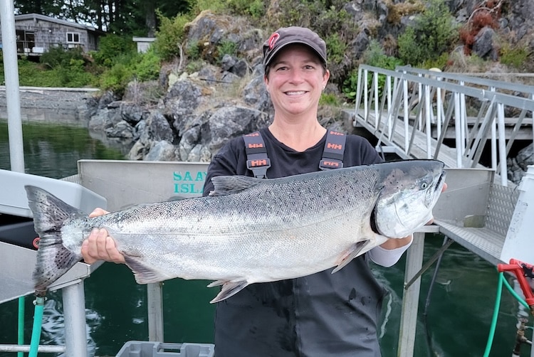 Mark-Selective Fisheries Can Be Successful Angler Kristen Shardlow holding a large hatchery-produced Chinook salmon, highlighting the success of BC recreational fisheries.