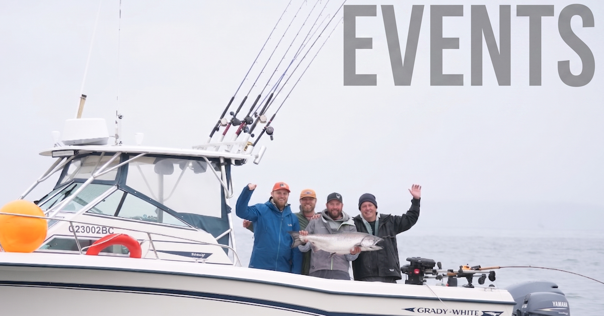 Four happy fishermen on a private charter boat in Barkley Sound Vancouver Island BC proudly displaying a large chinook salmon they just caught on a Fishing Derby.