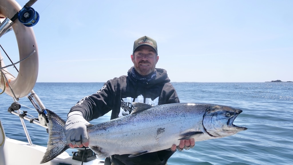 Adrian O'Connor holding large fish on boat