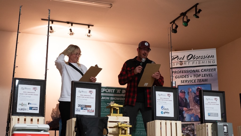 Angie Vincent and Adrian O'Connor at a fishing event announcing winners.
