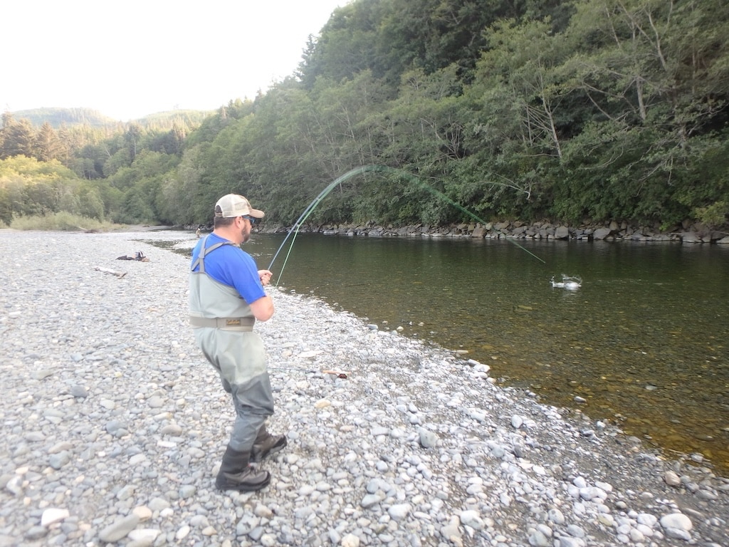 The Complete Guide to Sinking Fly Lines Fly fisherman on Vancouver Island small river catching a pink salmon on a float line with sink tip