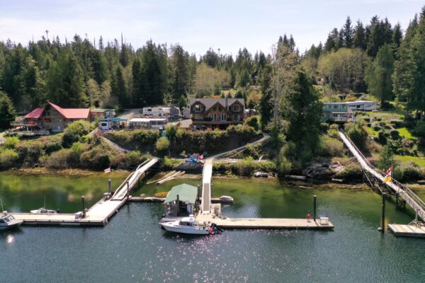 Stunning exterior view of the luxury Bamfield waterfront property at 326 Tower Road featuring a massive private dock.