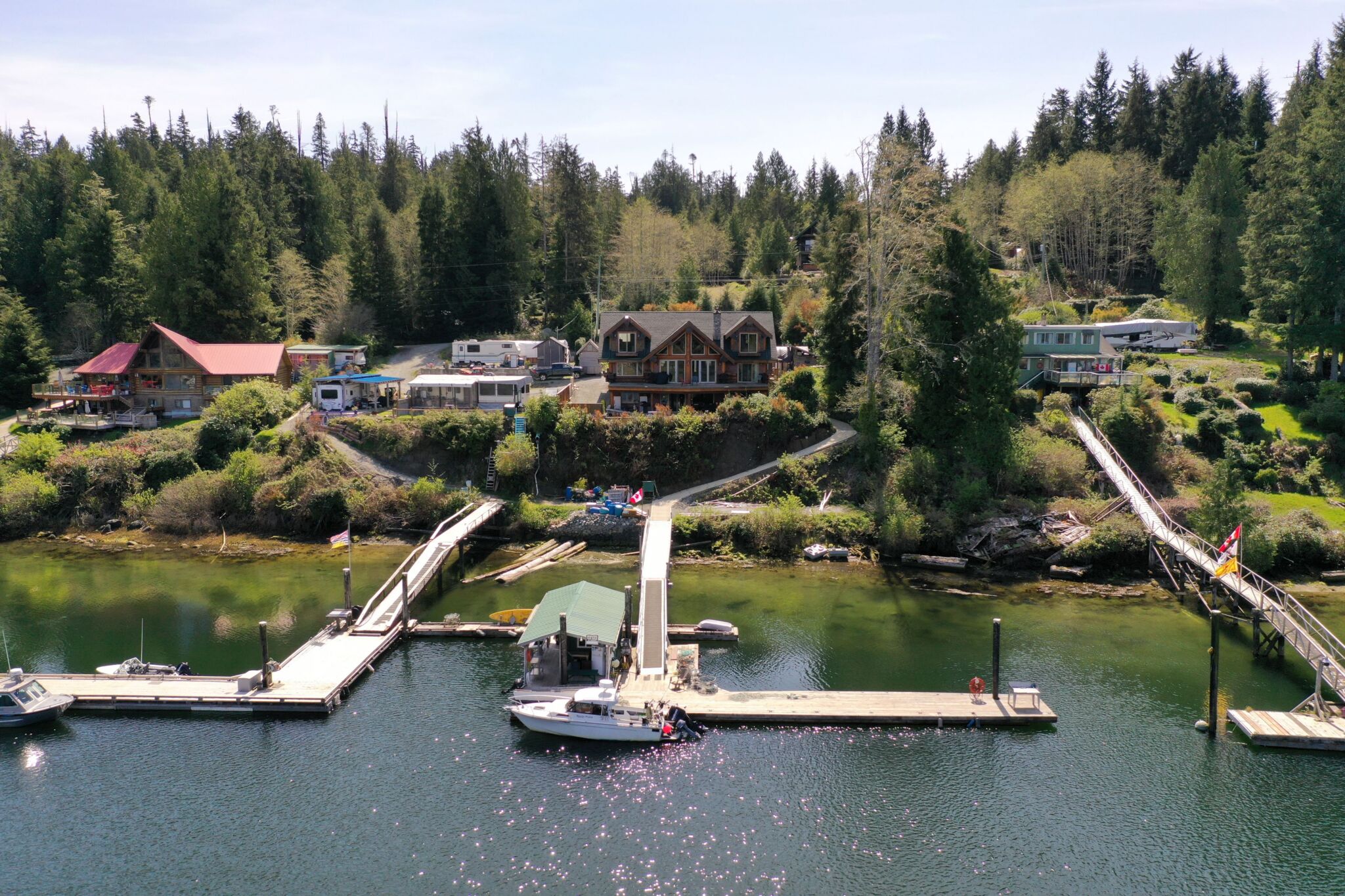 Stunning exterior view of the luxury Bamfield waterfront property at 326 Tower Road featuring a massive private dock.