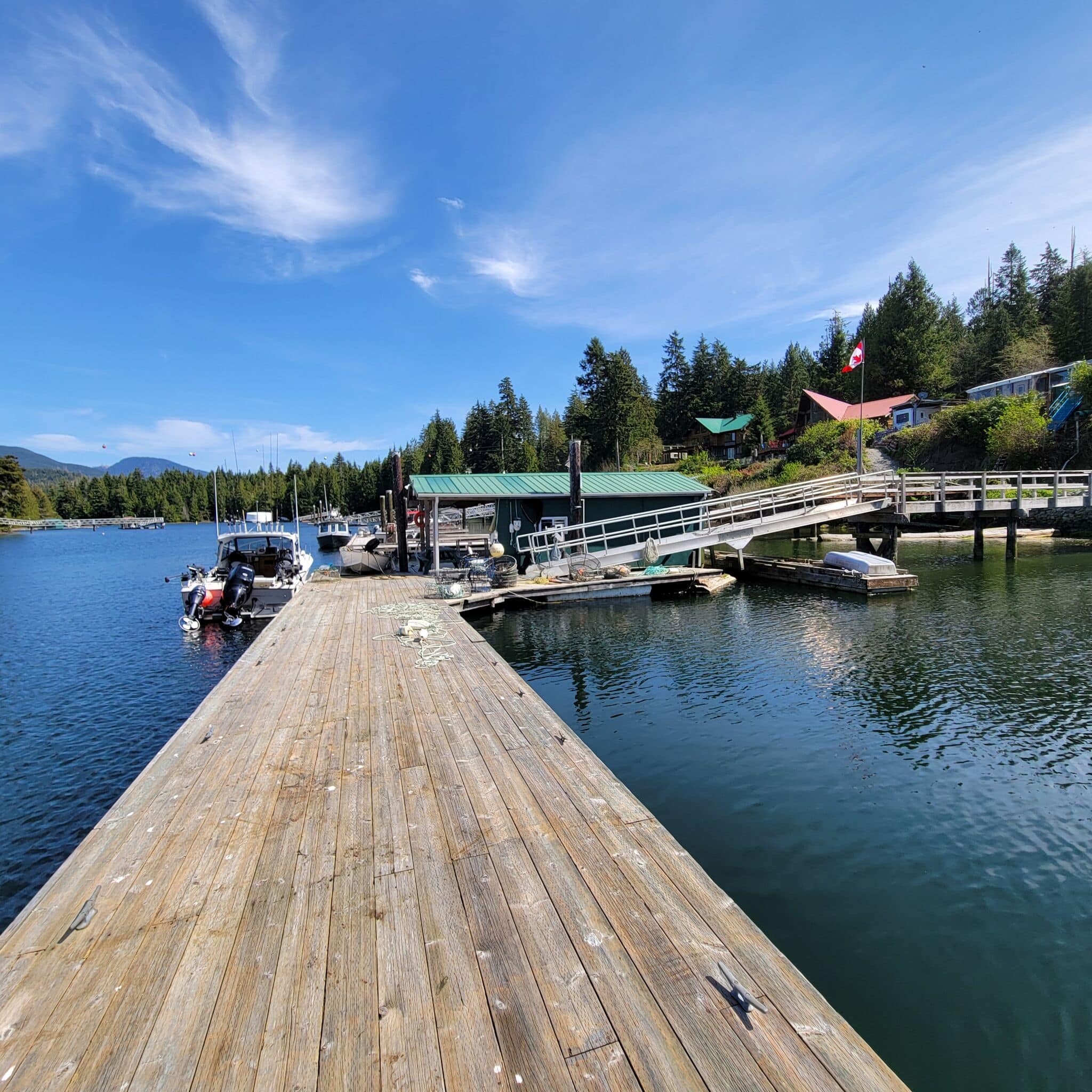 Ultimate Angler's Dream: 326 Tower Road in Bamfield Heavy-duty sportfishing boat moored at the massive private deep-water dock of the Bamfield waterfront property.