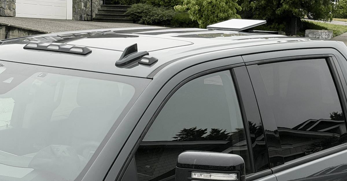 Starlink Mini for boat and truck setups demonstrated on a GMC Sierra in a residential neighbourhood.