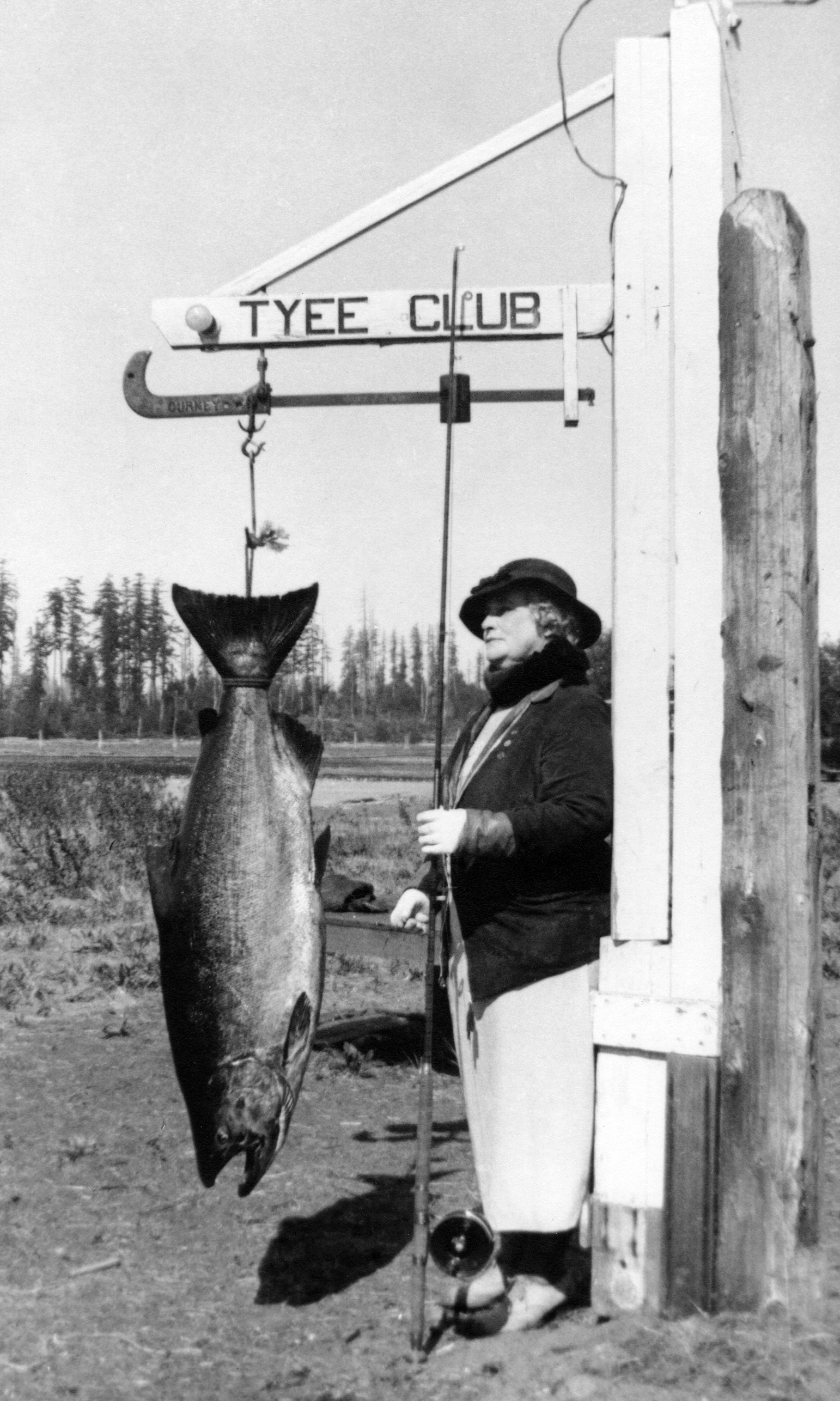Mrs WC Butler 1934 Tyee Man with her massive 60.5 lb Tyee salmon at the Campbell River scale