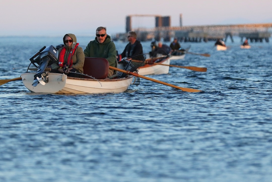 Traditional rowboats trolling for Tyee salmon in the Tyee Pool with outboard motors tilted up