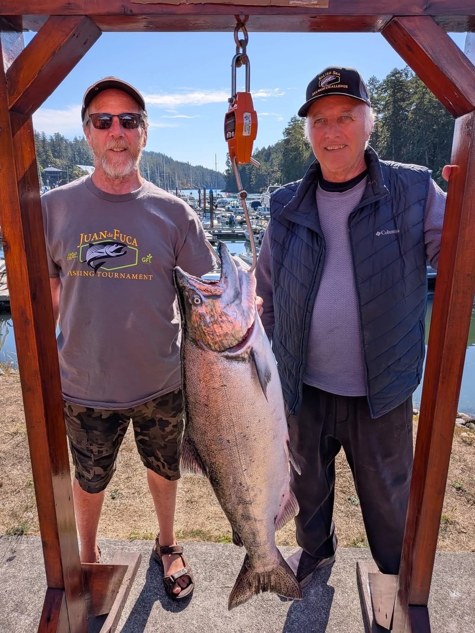 2026 Juan de Fuca Fishing Tournament Raises $80K 2026 Juan de Fuca Fishing Tournament winner Brian Stewart on right with 28.88 lb winning Chinook salmon at Pedder Bay