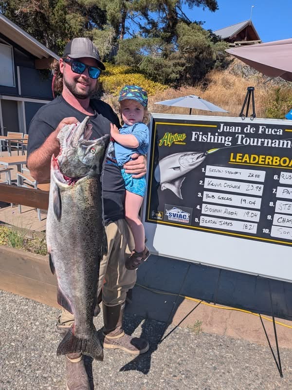 2026 Juan de Fuca Fishing Tournament Raises $80K Angler and young child at the 2026 Juan de Fuca Fishing Tournament leaderboard at Pedder Bay Marina