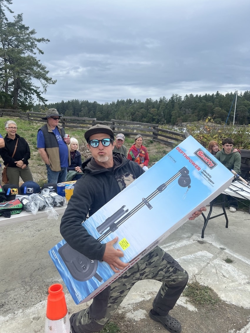 2026 Silva Bay Fishing Derby Raises ~$8,500 Harry Kartar playing air guitar with his Scotty electric downrigger donated by Pacific Rim Marine for 6th place Chinook