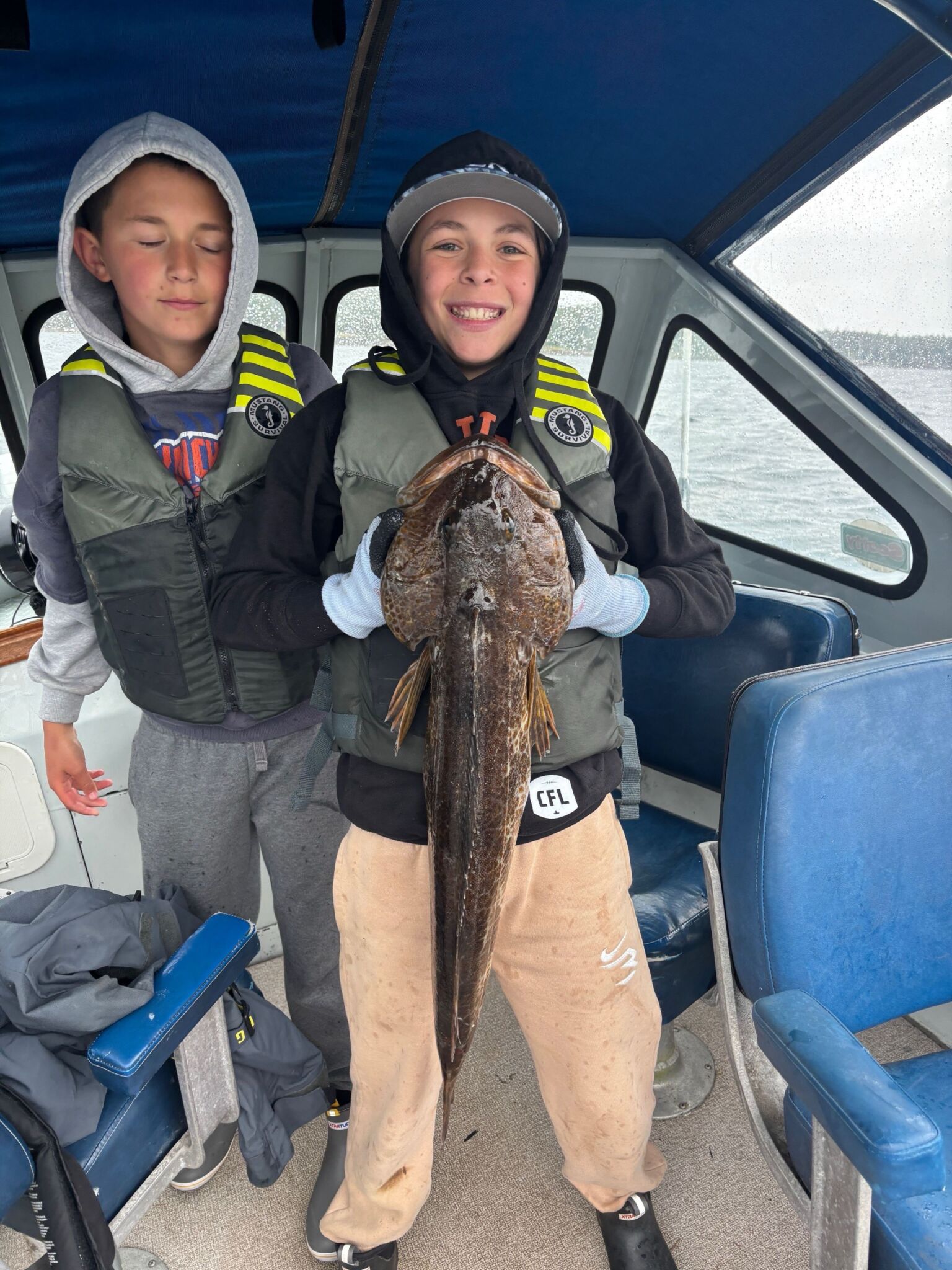 The Science Behind Pipe Jigs for Lingcod A happy young fisherman holding a bottom fish