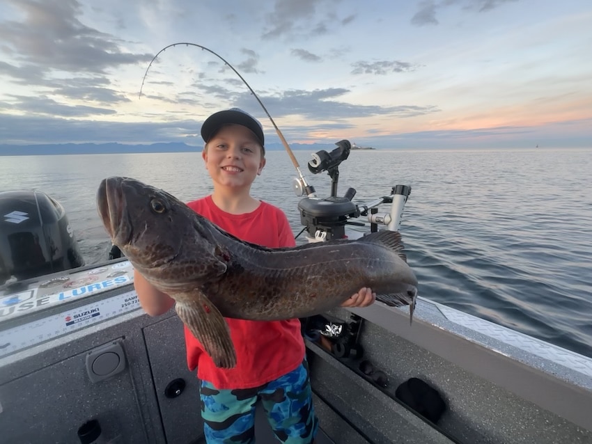 The Science Behind Pipe Jigs for Lingcod Young angler holding a lingcod nearly as big as himself